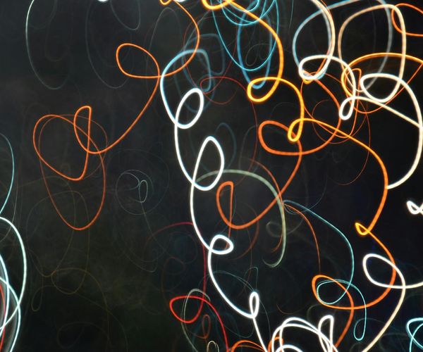 Abstract image representing flow and energy with green and dark colors.